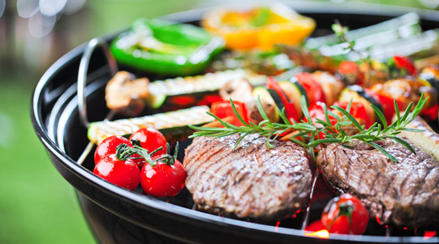 Hiiligrillin puhdistus Hiiligrillissä lihaa ja vihanneksia kypsymässä