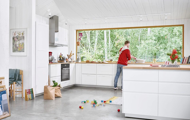 Ohjaa uunia, vaikka et olisi itse keittiössä Mies valmistaa ruokaa keittiössä Electrolux-älyuunilla.