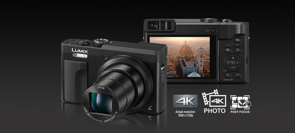 Panasonic LUMIX TZ90 Kaksi mustaa TZ90-kameraa, yksi nähtynä takaa ja toinen edestä. Toisen kameran objektiivi on zoomattu täysin.