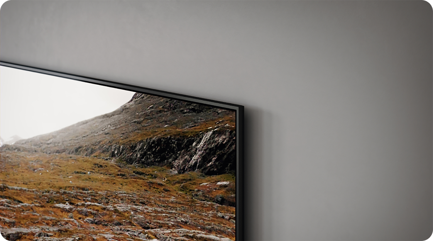 Lähikuva harmaalla seinällä olevasta Samsung Q60C -television kulmasta
