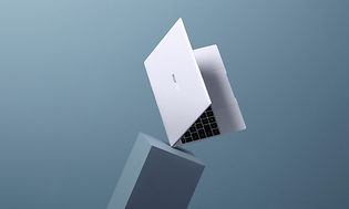 Hopeanvärinen Huawei MateBook X asetettuna kulmasta jalustan päälle