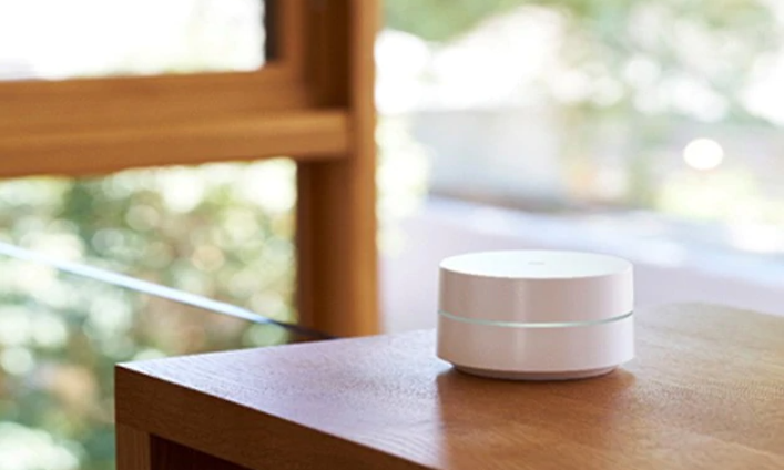 Valkoinen Google WiFi mesh pöydällä, taustalla ikkuna