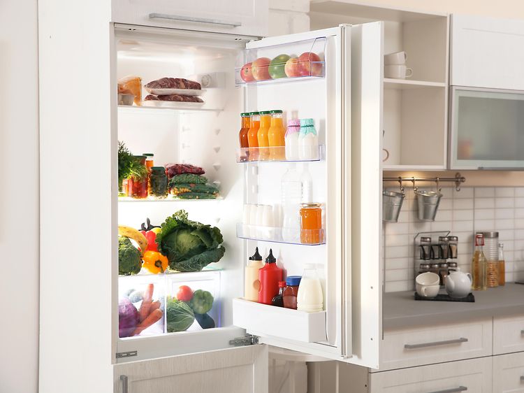 Integroitava jääkaappi, jonka ovi auki valkoisessa keittiössä