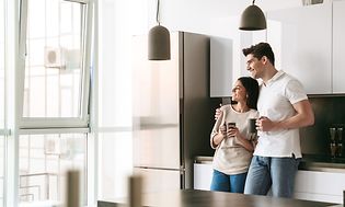 Couple standing in their new kitchen