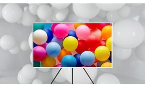 Värikkäitä ilmapalloja Samsung The Frame TV:n näytöllä, joka on asetettuna jalustalle 