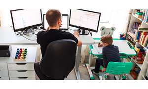 Computing - home office - Man sitting in his home office with a boy sitting next to him - 1260x600