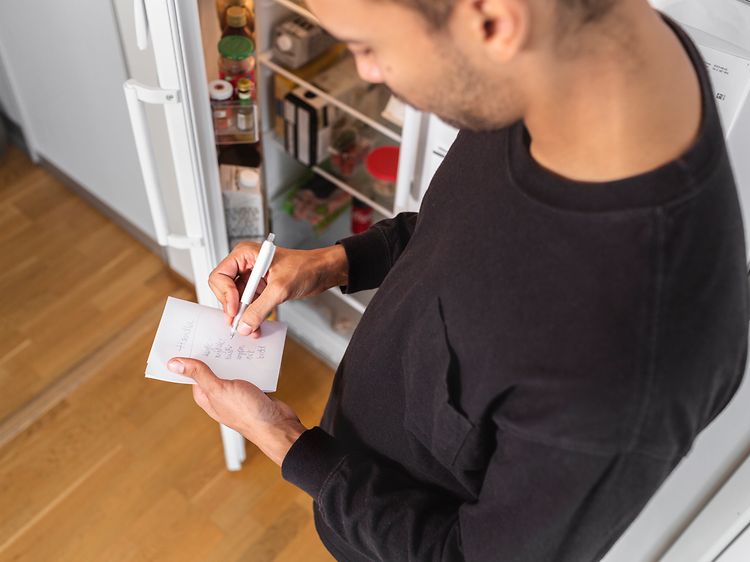 MDA-Fridges-Man taking notes in fron of an open fridge