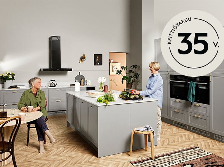 Kaksi naista Epoq-keittiössä ja 35 vuoden takuu logo