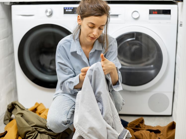 MDA-Washing machine-Woman checking laundry