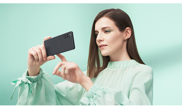 Nainen käyttää Xperia 10 -älypuhelinta