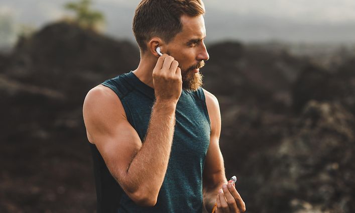 TV, kuulokkeet ja ääni - Earbuds-kuulokkeet - nappikuulokkeet - Mies juoksee ulkona langattomat kuulokkeet korvissaan