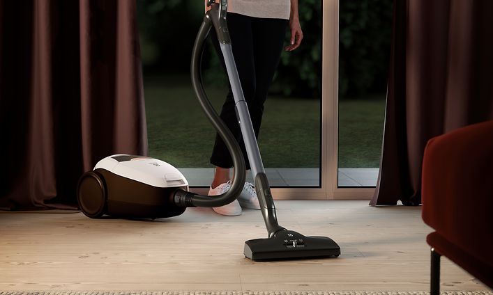 Nainen käyttää Electrolux Pure 9 -pölynimuria imuroimiseenm cleaner