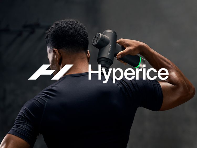 Hyperice logo on top of a man using the Hypervolt massage gun