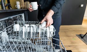 B2B - How to choose dishwasher for the workplace kitchen - Man empyting a dishwasher at work