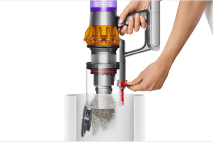 Nainen tyhjentää Dyson V15 Submarine -imurin pölysäiliötä