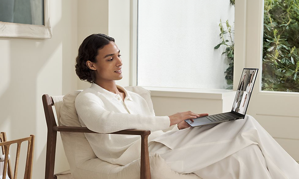 Nainen ja Asus Zenbook S 14 -kannettava sylissään