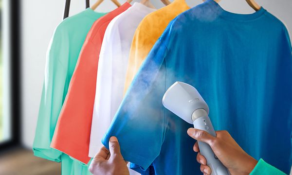 Philips - Kannettava vaatehöyrystin - Philips-vaatehöyrystin ja eri väriset silitettävät t-paidat