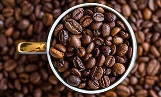 Coffee beans in a coffee cup
