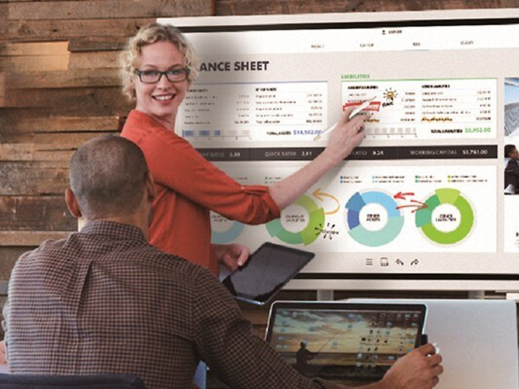 Woman presenting on Samsung Flip flipboard in meeting